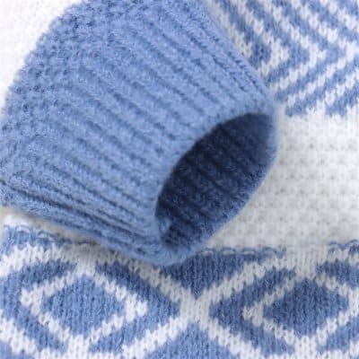 Soft blue knitted scarf with intricate white geometric pattern, perfect for cold weather, stylish and warm, ideal for winter fashion accessories.