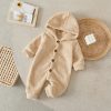 Soft beige baby fleece jumpsuit with hood and button closure, perfect for newborns and infants, ideal for cozy winter or fall wear.