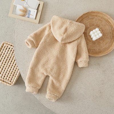 Soft beige cozy baby jumpsuit made from plush fleece material, perfect for winter and home wear. Ideal for newborns and infants, providing warmth and comfort in cold weather.