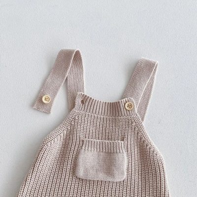 Soft beige knitted baby overalls with button straps and front pocket, ideal for comfortable children's fashion and accessories at Monalisa Store in opt.