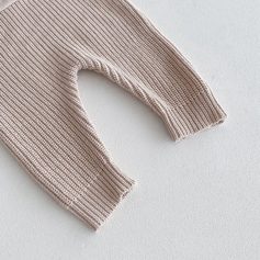 Soft beige knitted sweater sleeve, cozy warm clothing ideal for fall and winter seasons, perfect for casual wear and stylish layering.