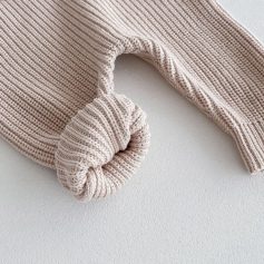 Soft beige knit sweater with a cozy folded cuff, perfect for fall and winter fashion accessories.