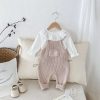Comfortable baby clothing set featuring a white lace-collared top and beige knitted overalls, ideal for infant fashion, cozy and stylish for everyday wear.