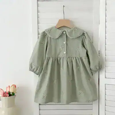 Flower embroidered children’s dress, pastel green, with lace-trimmed collar and puffed sleeves, perfect for kids' fashion and special occasions.