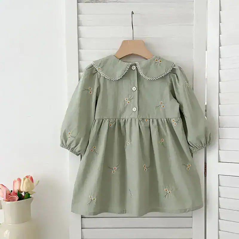 Flower embroidered children’s dress, pastel green, with lace-trimmed collar and puffed sleeves, perfect for kids' fashion and special occasions.
