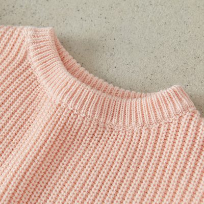 Soft pink knitted sweater close-up, comfortable and cozy fashion clothing, perfect for casual wear and stylish outfits, ideal for women seeking quality knitwear.