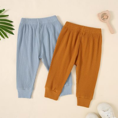Comfy ribbed children's jogger pants in pastel blue and warm caramel, perfect for casual wear and outdoor play. Made from soft, breathable fabric for all-day comfort.