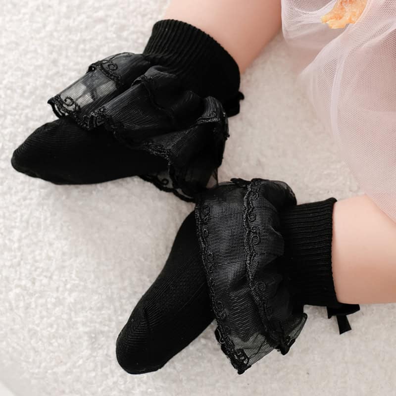 Black lace-trimmed baby socks with ruffle details, suitable for infants and toddlers, perfect for comfort and style at Monalisa Store.