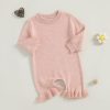 Soft pink baby onesie with ruffled ankles, perfect for newborns and infants, made from comfortable, breathable knit fabric. Ideal for everyday wear or special occasions.