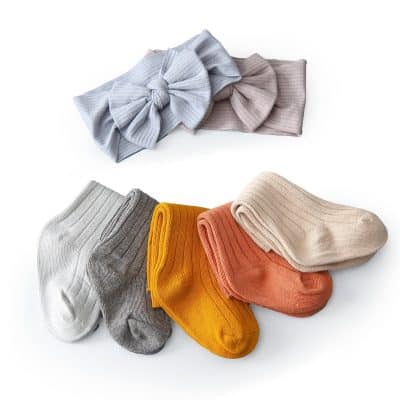 Soft pastel headbands and colorful socks for women and children on white background.