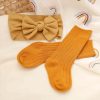 Soft mustard yellow ribbed socks and matching headband with a bow on a cozy white background. Perfect for stylish, comfortable women's fashion accessories at Monalisa Store.