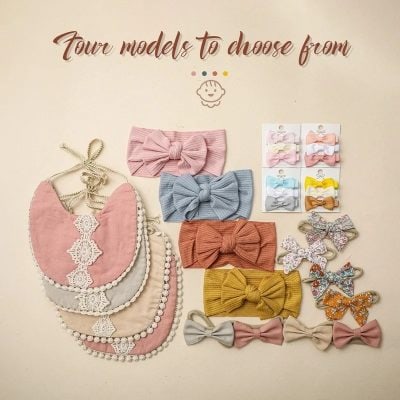 Pink and blue bow hair accessories displayed with matching bibs for babies at Monalisa Medical Store. Perfect for stylish infants and toddlers.