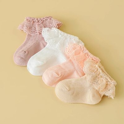 Colorful lace-trimmed baby socks in pastel shades including pink, white, peach, and beige, perfect for newborns and infants, combining comfort and elegant design for stylish baby footwear.