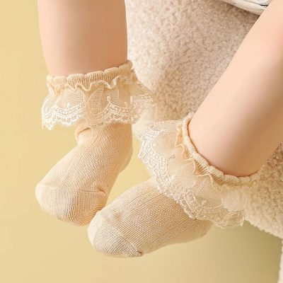 Comfy beige lace-trimmed baby socks, adorable infant footwear, soft cotton material, ideal for delicate baby feet, perfect for newborns and infants, stylish and comfortable kids’ accessories.