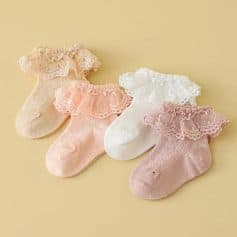 Delicate baby girl socks with lace ruffles in pastel pink, white, and beige, perfect for infants, featuring soft cotton material and charming design.