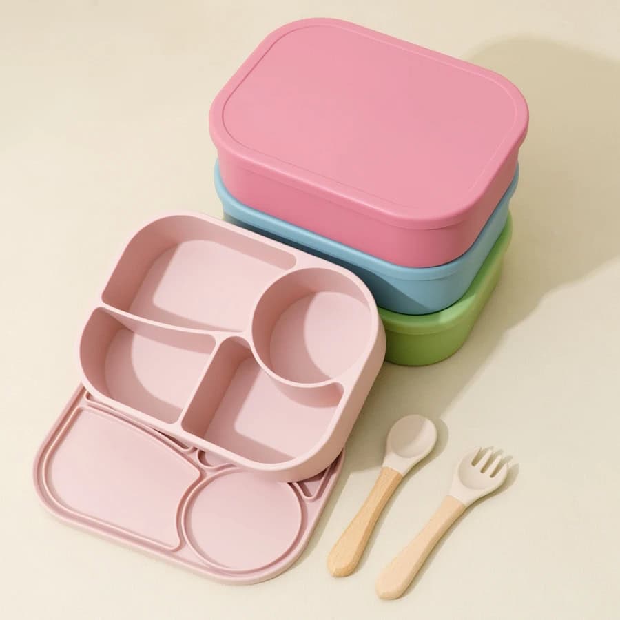 Colorful eco-friendly kids' lunchboxes with compartments and matching utensils for healthy meal storage, ideal for school or daycare. Stylish and practical lunch containers for children.