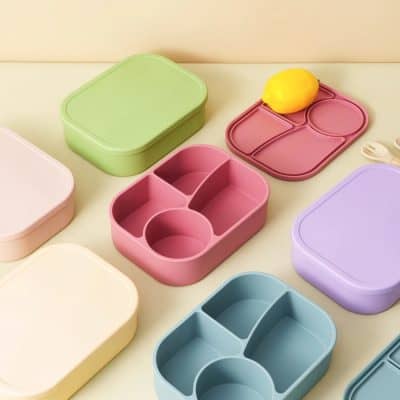 Colorful plastic lunchboxes with divided compartments, ideal for kids' meals, meal prep, and school lunches, showcasing vibrant pastel tones and functional design.