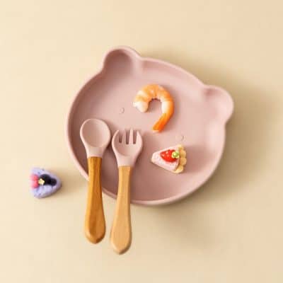 Shrimp-shaped food on bear-shaped pink plate with wooden utensils, cute baby food set, healthy snacks for infants, Monalisa Medical store product display.