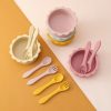 Colorful silicone children's bowls and utensils set, perfect for kids' meals and snacking, featuring soft pastel pink, yellow, and white colors.