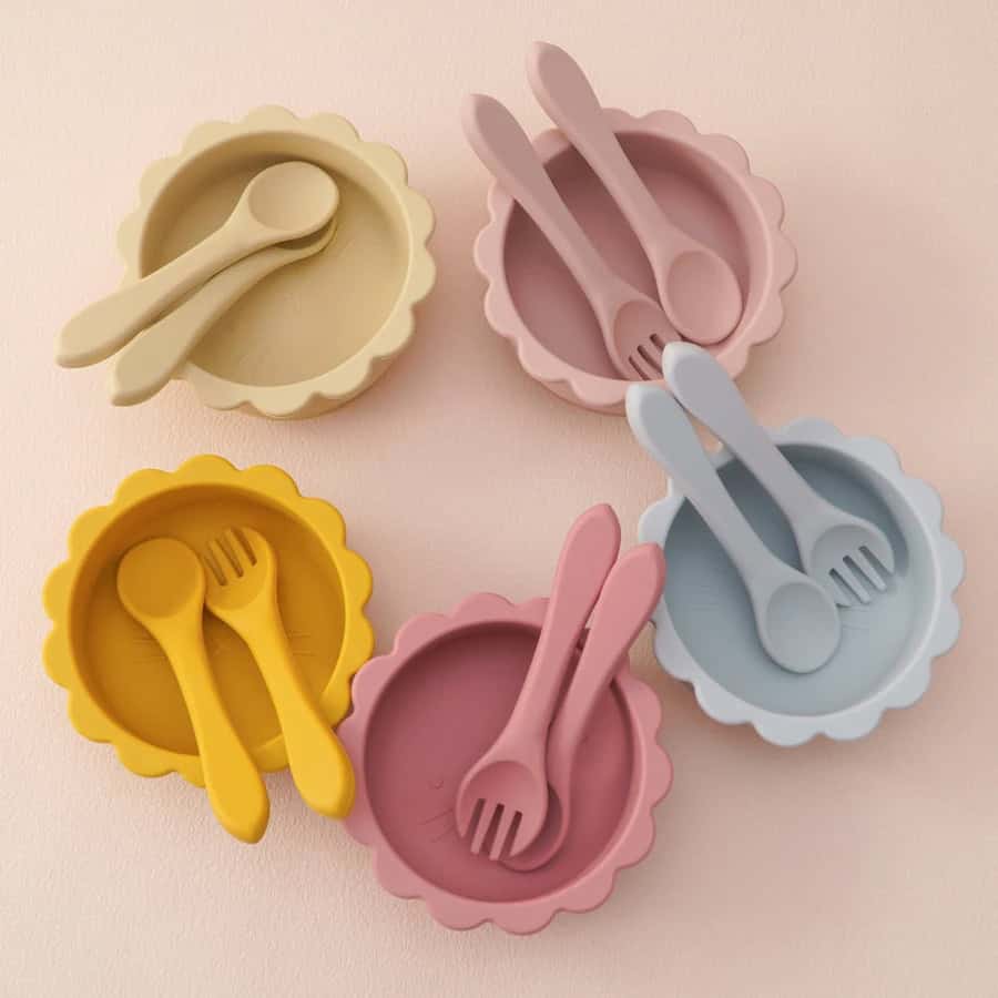Silicone baby bowls with matching spoons and forks in pastel colors, ideal for infant feeding and toddler meals, available at Monalisa Store.