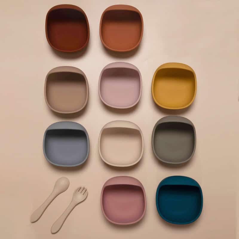 Square ceramic dishes in various pastel and earthy colors with matching spoons, ideal for food presentation or decorative purposes.