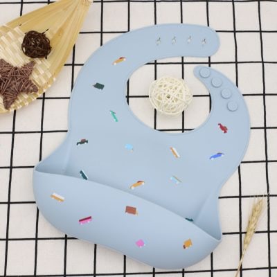 Colorful baby silicone bib with truck patterns, easy to clean, perfect for feeding time, safe for infants, and stylish children's dining accessory.