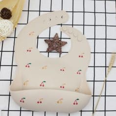 Cherry-patterned baby bib with adorable design, perfect for feeding and drool protection, made of soft, washable material for comfortable use.