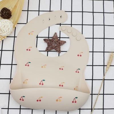 Cherry-patterned baby bib with adorable design, perfect for feeding and drool protection, made of soft, washable material for comfortable use.