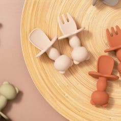 Minimalist baby teether toys on wooden plate, safe silicone teething rings, orthodontic baby teethers for infants, soft chew toys for soothing gums, Monalisa Store baby product collection.