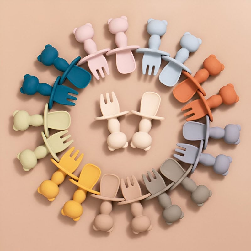 Colorful silicone baby spoon and fork set arranged in a circle, perfect for baby feeding, soft, safe, and BPA-free, available at Monalisa Store.