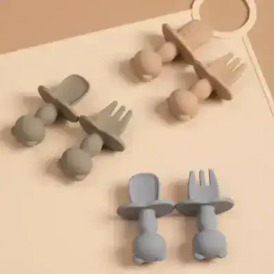 Wooden baby teethers with spoon and fork shapes for infants and toddlers for sensory play and teething relief.