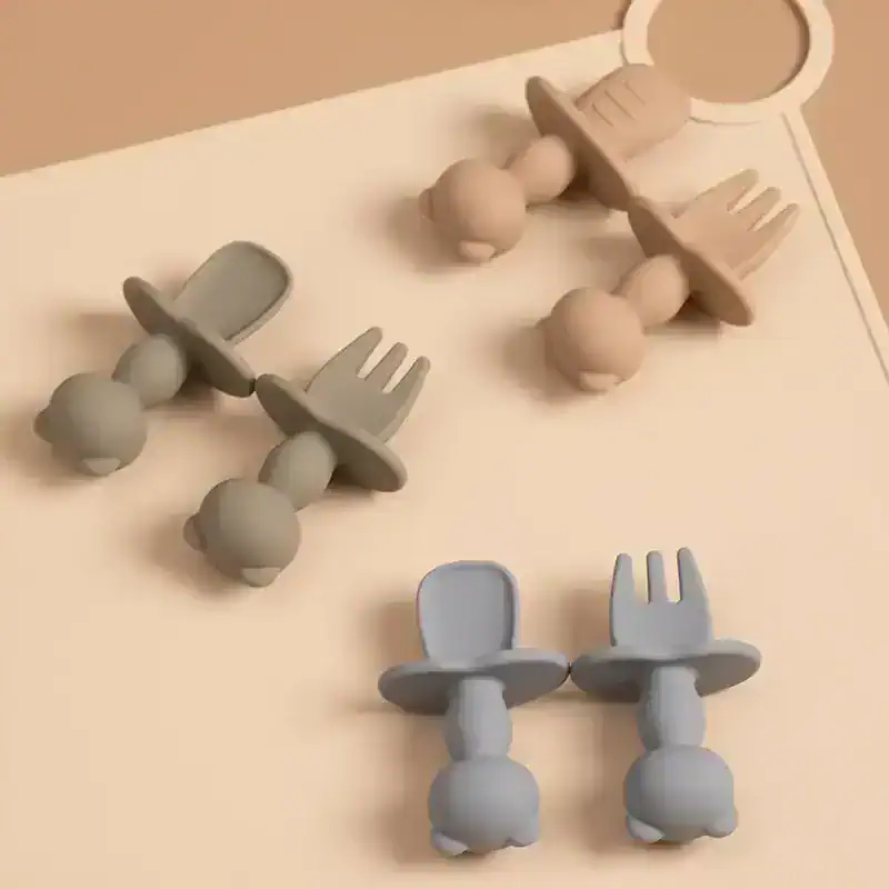 Wooden baby teethers with spoon and fork shapes for infants and toddlers for sensory play and teething relief.