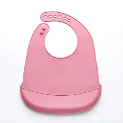 Silicone baby bib pink adjustable waterproof lightweight food catch designer infant feeding accessory.
