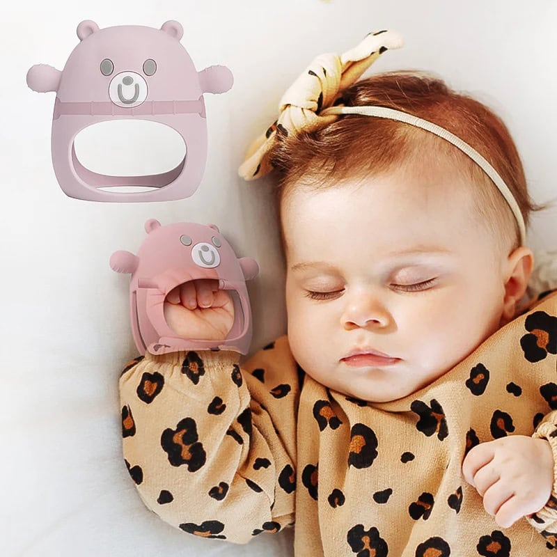 Button-shaped teething toy with bear face design for infants.