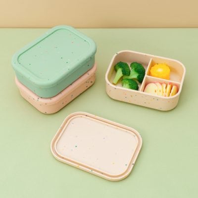 Meals on the go: pastel-colored food storage containers with broccoli, yellow cauliflower, and sliced cheese, perfect for healthy snacks and meal prep at Monalisa Medical Store.