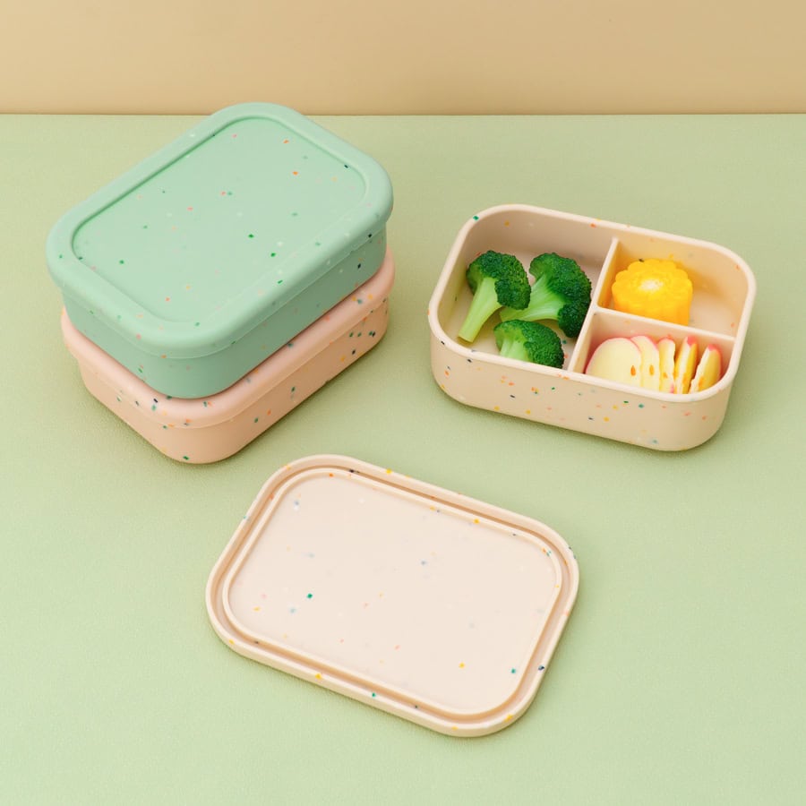 Meals on the go: pastel-colored food storage containers with broccoli, yellow cauliflower, and sliced cheese, perfect for healthy snacks and meal prep at Monalisa Medical Store.
