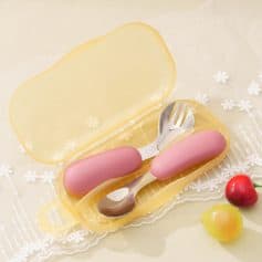 Pink baby utensils set in a yellow case, ideal for infants and toddlers, perfect for feeding and caregiving.