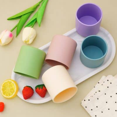 Pastel-colored cups and fresh strawberries and lemon slices on a white tray, with tulips and polka dot napkin, perfect for stylish tableware at Monalisa Store for optical and aesthetic accessories.