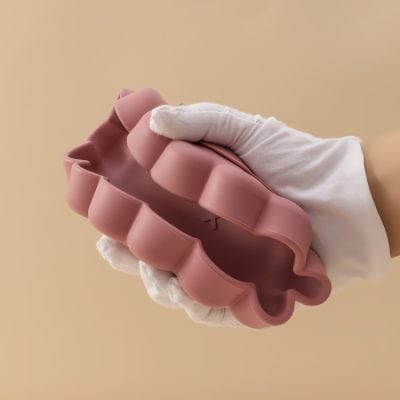 Flexible pink flower-shaped silicone mold for baking and cooking, ideal for creative food presentation. Perfect for making candies, chocolates, or decorative desserts with unique floral designs.