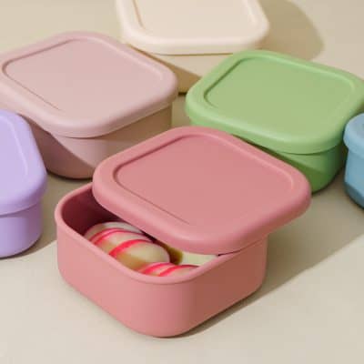Colorful silicone food storage containers in pastel pink, green, purple, and blue, designed for preserving and organizing snacks and meals, ideal for kitchen and travel use.