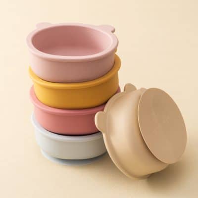 Stacked silicone baby bowls in pastel colors, suitable for infant feeding.