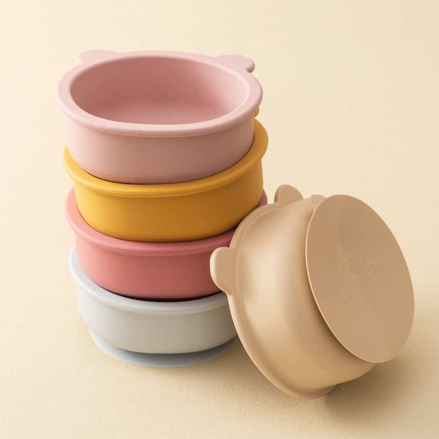 Stacked silicone baby bowls in pastel colors, suitable for infant feeding.