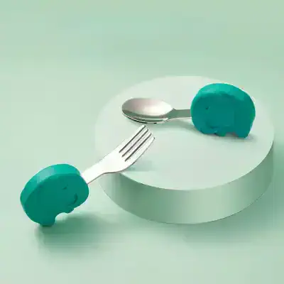 Elephant-themed baby cutlery set with a fork and spoon designed for children, featuring adorable elephant handles in teal color. Perfect for encouraging self-feeding and making mealtime fun for little ones.