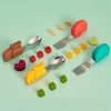 Colorful children's cutlery set with animal-shaped handles and matching food-shaped blocks, perfect for kids' mealtime fun and learning.