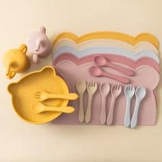 Colorful silicone baby dining set with bowls, plates, spoons, forks, and cutlery organizers, ideal for kids learning to eat and develop independence. Perfect for feeding and meal times.