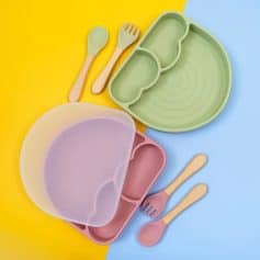 Colorful silicone dinnerware set with divided sections and matching bamboo utensils, perfect for kids’ meals and healthy eating.