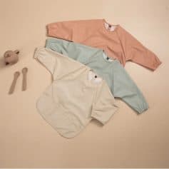 Soft pastel-colored oversized sweatshirts in peach, mint green, and cream, perfect for casual or loungewear, displayed on a neutral background with minimalist accessories.