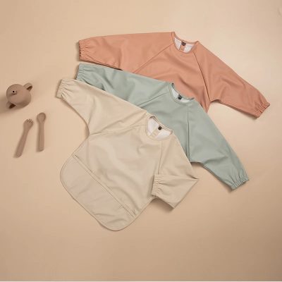 Soft pastel-colored oversized sweatshirts in peach, mint green, and cream, perfect for casual or loungewear, displayed on a neutral background with minimalist accessories.