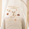 Soft baby cradle with plush bunny mobile, clouds, stars, and wooden hanging toys, perfect for nursery decor and infant comfort.