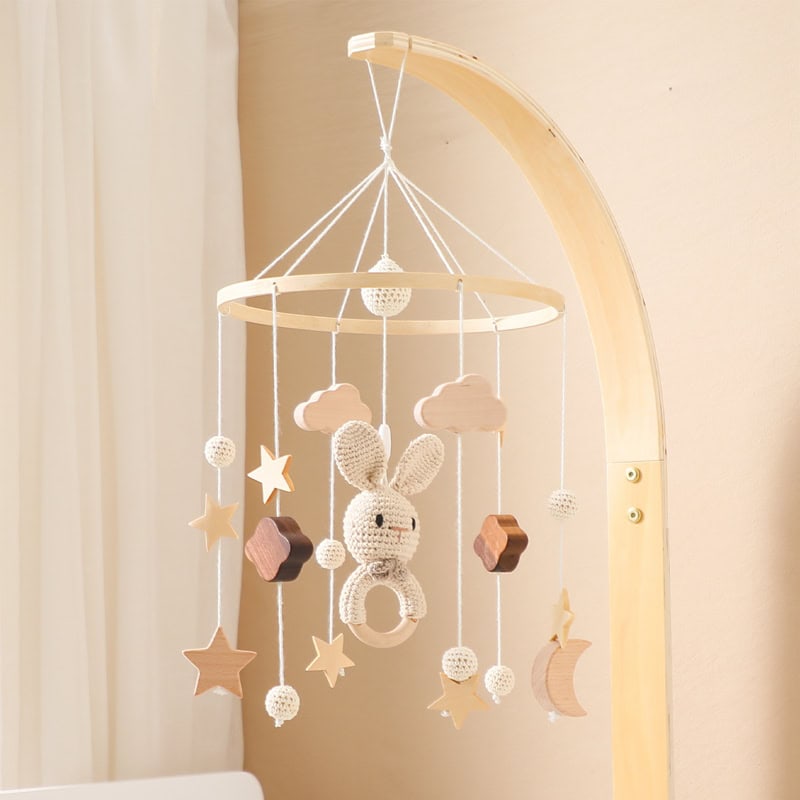 Soft pastel-colored baby mobile with cloud, star, moon, and bunny hanging decorations for nursery decor, ideal for infant comfort and sensory development.